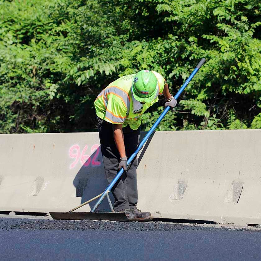 person paving road