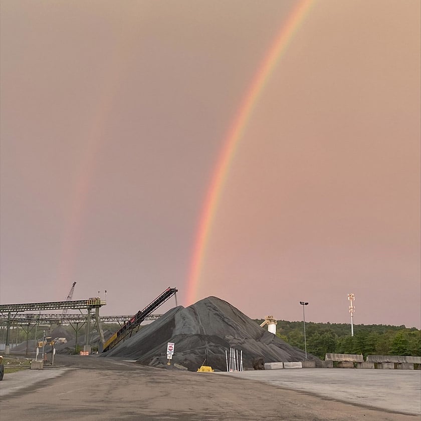 rainbow going into rock pile