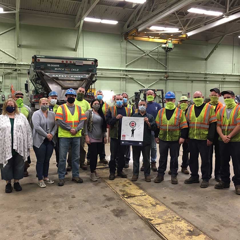 group of people holding safety pledge