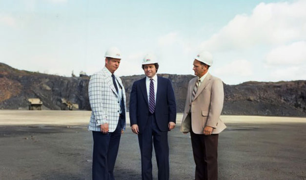 people wearing suits and hard hats